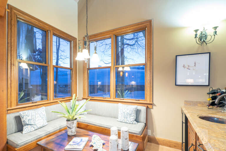 A corner seating area with cushioned benches and coffee table. A corner seating area with cushioned benches and coffee table.