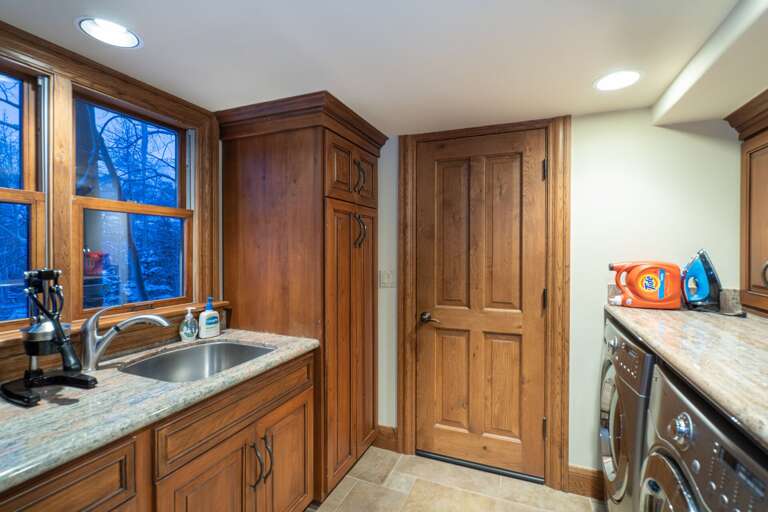 Laundry room with sink and stainless steel washer and dryer. Laundry room with sink and stainless steel washer and dryer.