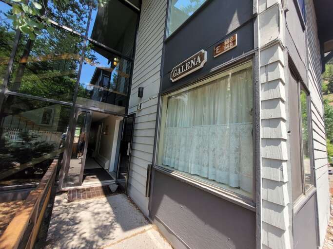 Storefront with lace curtains in window