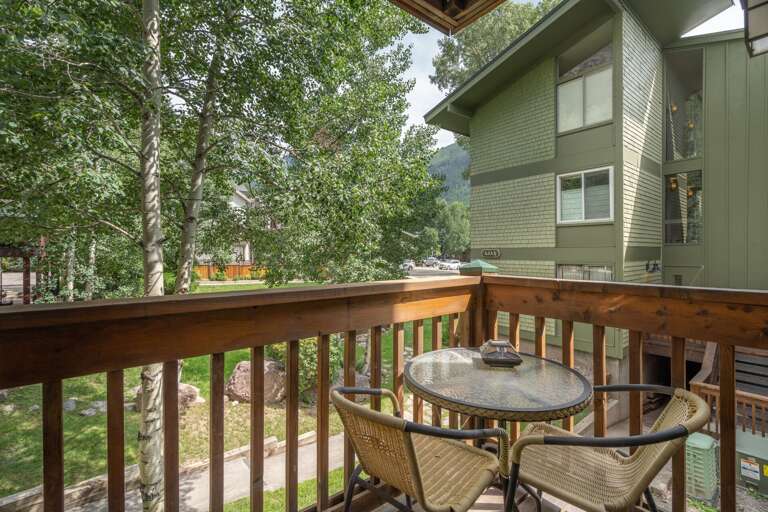 The balcony with a table and two chairs