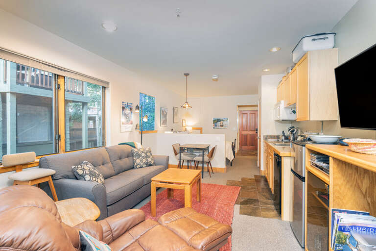 Bright Living Space With Sofa Set And Kitchen Area