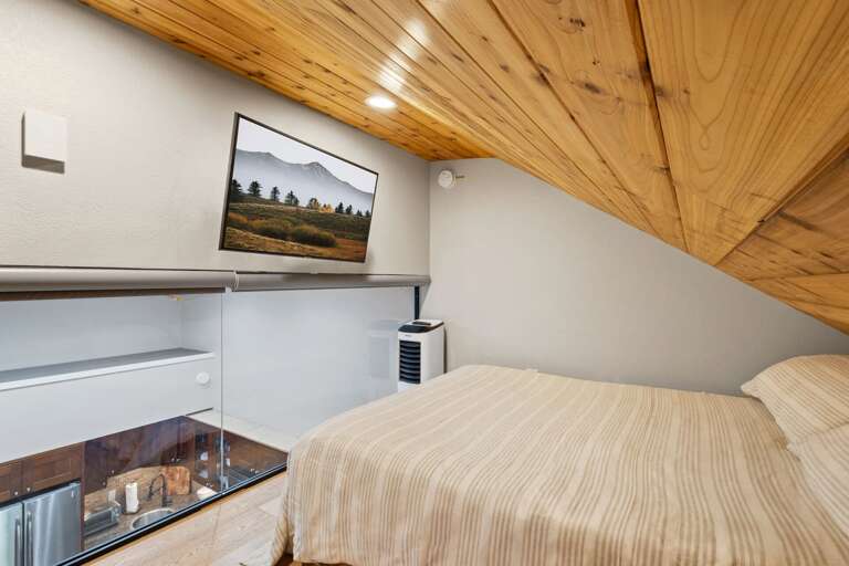 Head up to the second floor and to the first of two cozy lofts.  Enjoy cool summer days with the portable AC unit. Queen bed. Head up to the second floor and to the first of two cozy lofts.  Enjoy cool summer days with the portable AC unit. Queen bed.