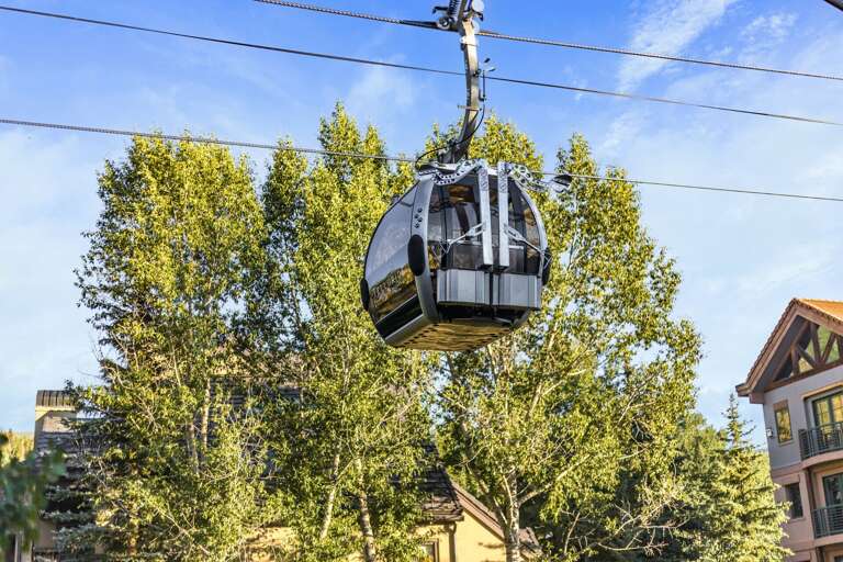 A Summer view of the gondola passing by the balcony. A Summer view of the gondola passing by the balcony.