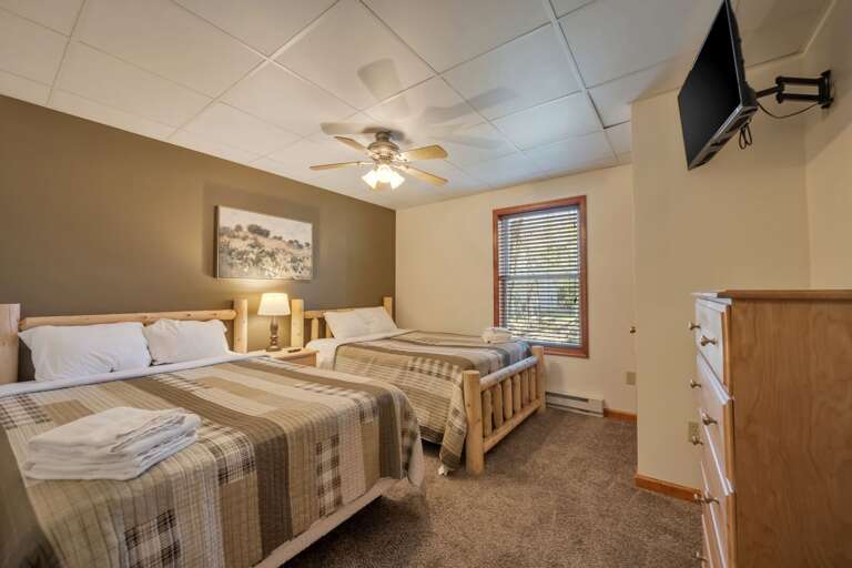 1st Floor Bedroom 2 with 2 Full Beds, TV & Storage.