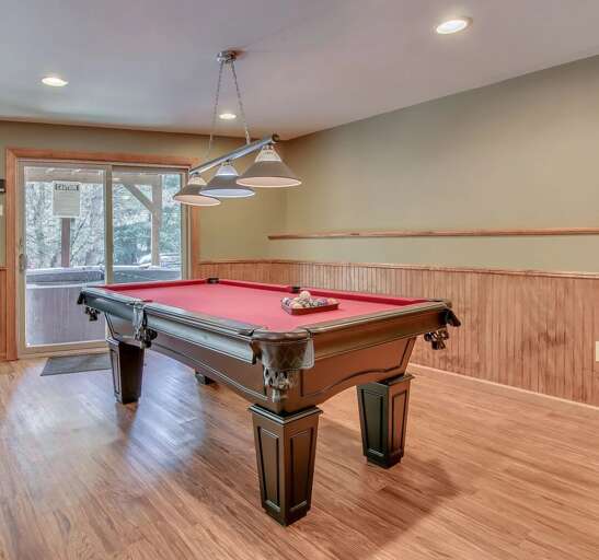 The game room, with a pool table in the center of the room. The game room, with a pool table in the center of the room.