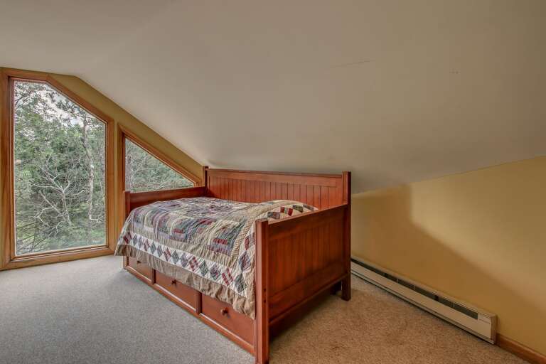 A small futon on the upper floor, by the window.