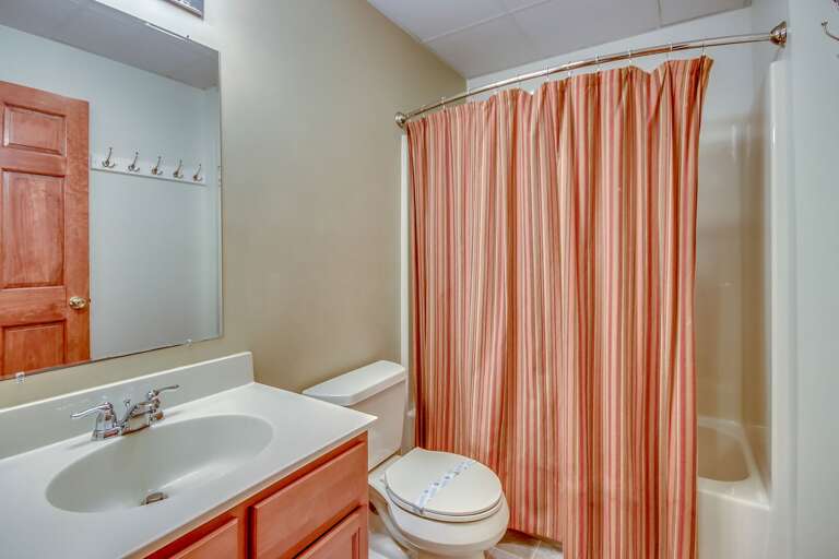 Bathroom Sink with Mirror, a Toilet, and Bathtub.