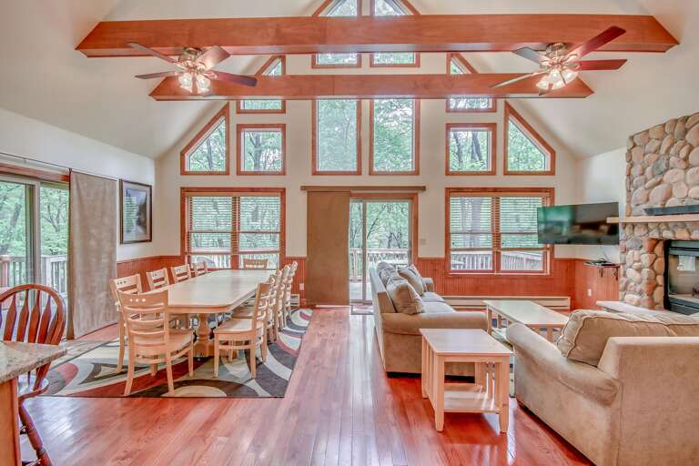 Dining and Living Room Area with a Fireplace and Ceiling Fan.