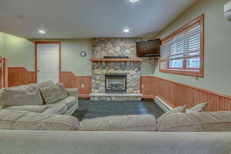 Downstairs TV Area in Game Room with Fireplace.