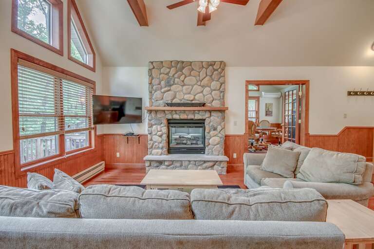Living Room with Fireplace, Couches, and TV.
