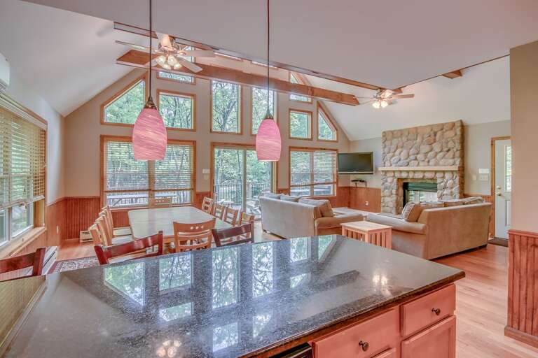 Interior shot of a dining room, kitchen island and sofas