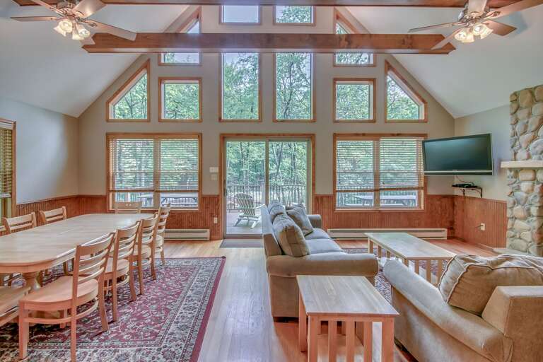 View of patio door, living room, and dining room