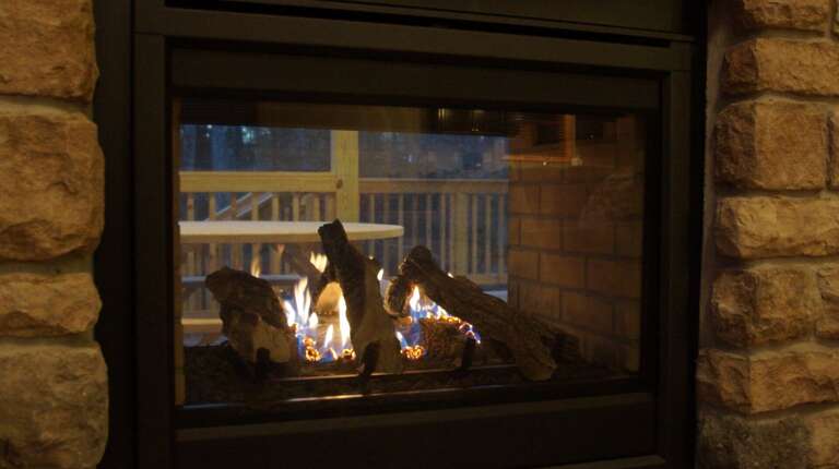 Fireplace with fire and logs
