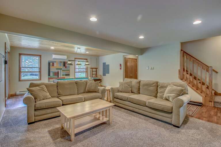 basement room with two couches and a coffee