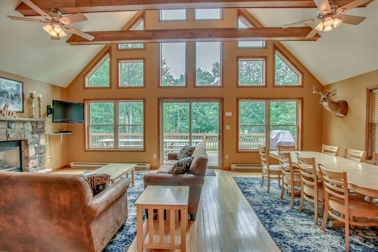 view of living room with couches, table, and patio doors