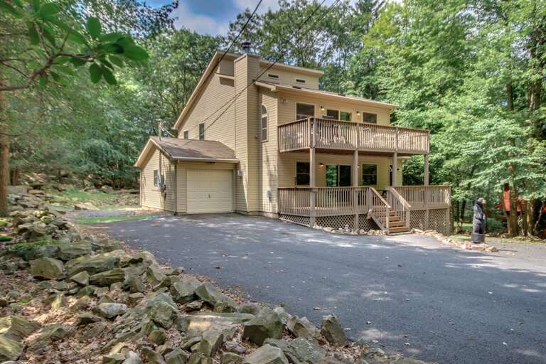 An angled shot of the exterior of this Lake Harmony rental, showing the garage and driveway. An angled shot of the exterior of this Lake Harmony rental, showing the garage and driveway.