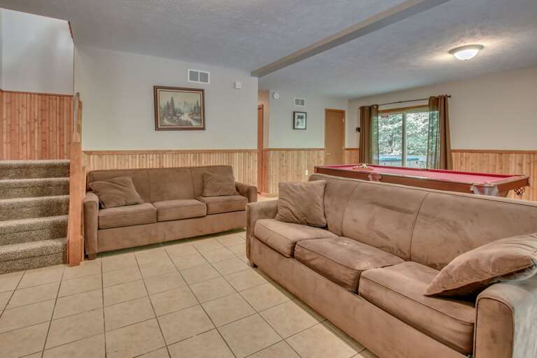 A picture of the two couches in the game room, with the pool table in the background. A picture of the two couches in the game room, with the pool table in the background.