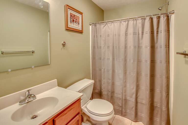 A picture of one of this Lake Harmony rentals bathrooms, with a toilet, sink, mirror, and shower in shot. A picture of one of this Lake Harmony rentals bathrooms, with a toilet, sink, mirror, and shower in shot.