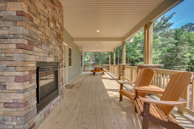Wraparound Porch with Chairs and Fireplace outside "On The Rocks"