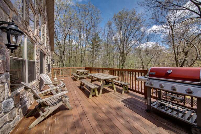 A Large Deck With Adirondak Chairs, Picnic Tables, and a Gas Grill. A Large Deck With Adirondak Chairs, Picnic Tables, and a Gas Grill.