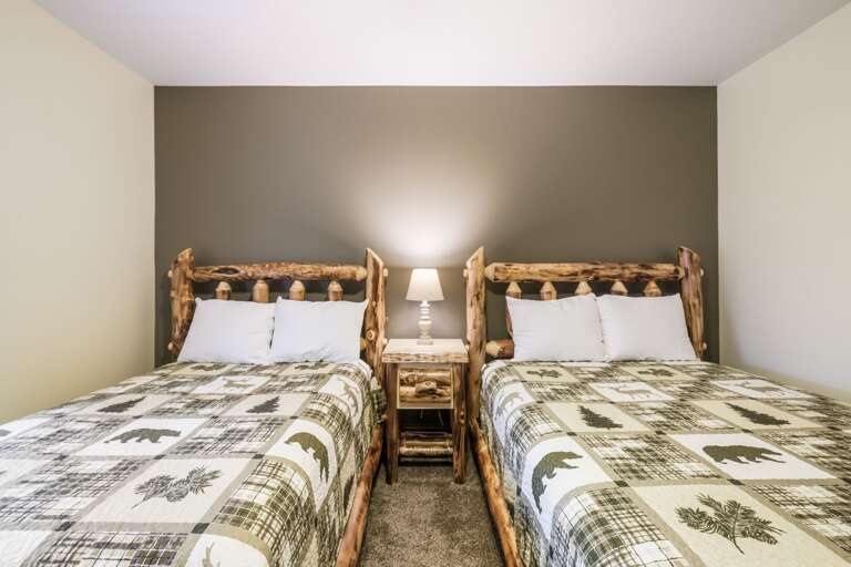 Bedroom Featuring Two Elk Patterned Beds