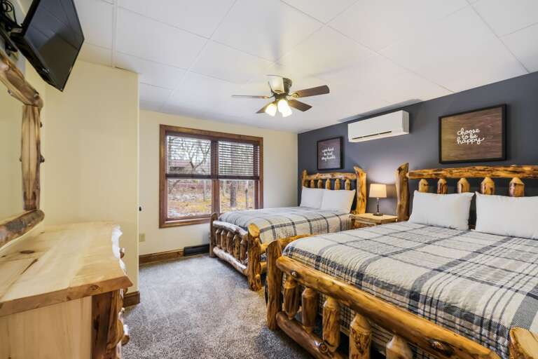 Bedroom with Matching Beds, Mounted TV and Large Window