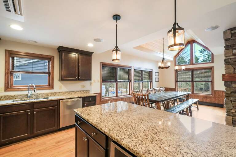 Kitchen and Dining Area with Overhead Lights