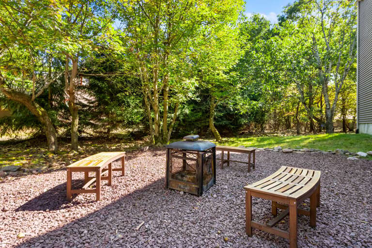 outdoor seating area at home for rent in lake harmony pa with benches and fire pit