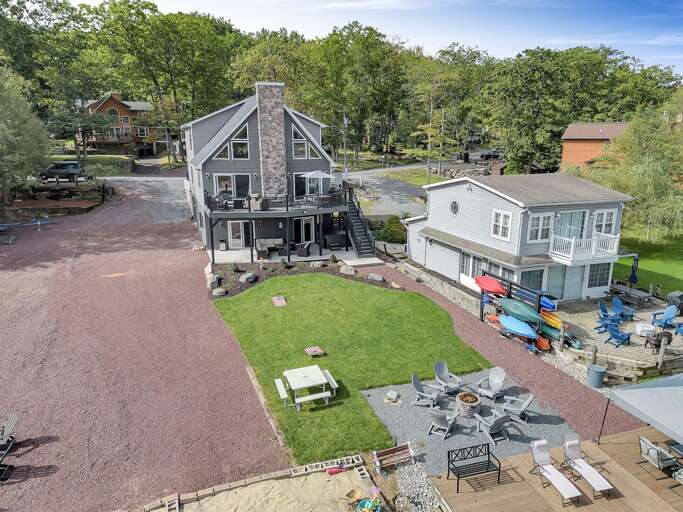 Backyard Amenities at Great Lake Escape include Corn Hole, Picnic Area, Fire Pit with Seating, Deck Chairs on the Dock and a Sandbox Backyard Amenities at Great Lake Escape include Corn Hole, Picnic Area, Fire Pit with Seating, Deck Chairs on the Dock and a Sandbox