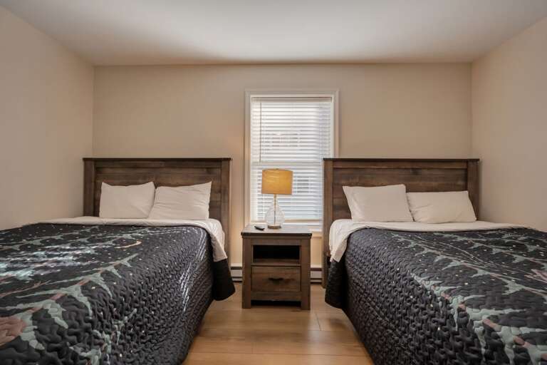 2nd Floor Bedroom 3 with 1 Queen Bed & 1 Full Bed, Storage & TV.