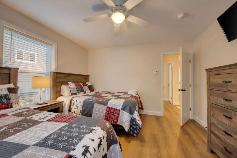 2nd Floor Bedroom 4 with 2 Queen Beds, Storage & TV.