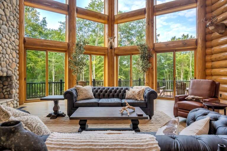 Log-lined Living Space With Soaring Windows Facing Lush Greenery