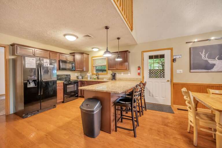 Release Your Inner Chef in the Modern Kitchen with Additional Seating at the Breakfast Bar