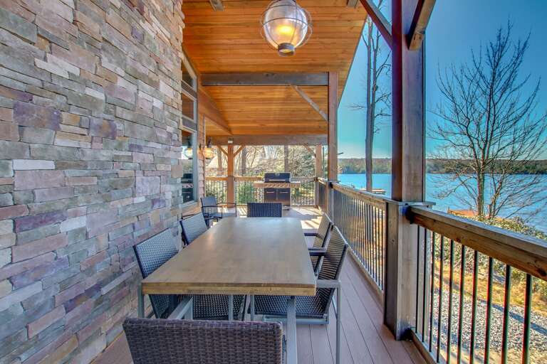 Picture of table and chairs, and the grill, of the second floor porch.