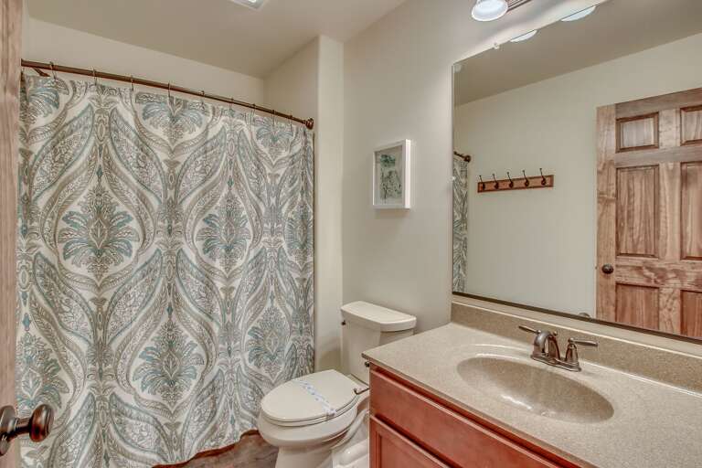 Bathroom with Sink, Toilet and Shower with Curtain