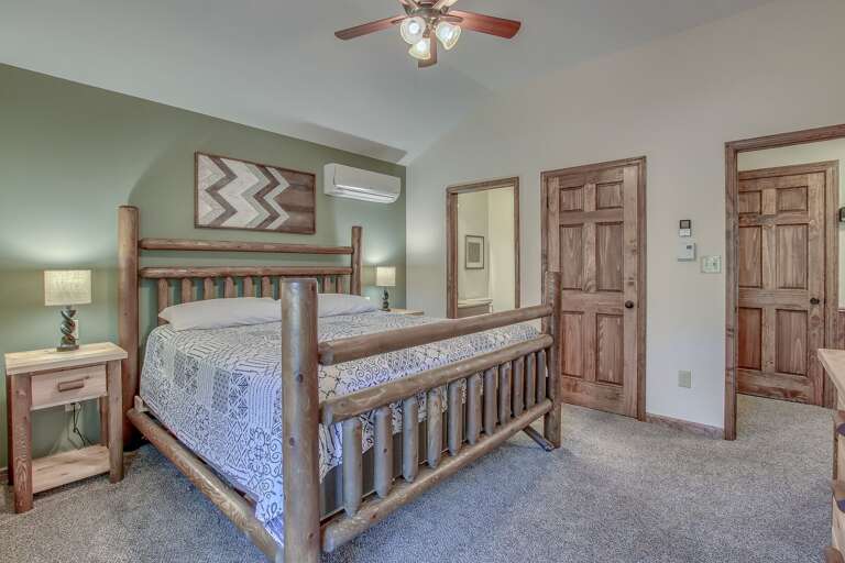 Large Bedroom with Wavy Artwork and Private Bathroom Access