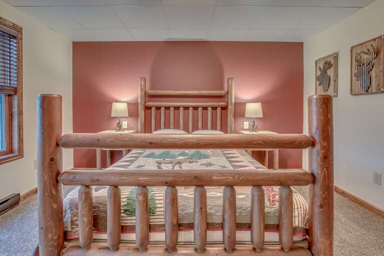 View of Bedroom with Bed, Chic Artwork, Nightstands with Lamps