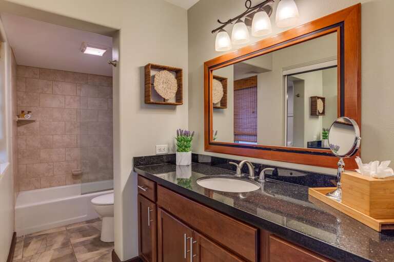 Bathroom with tub, great for adults and little ones.