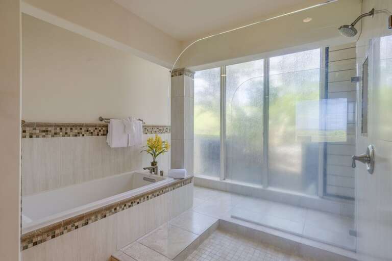 Master bathroom with soaking tub and separate shower.