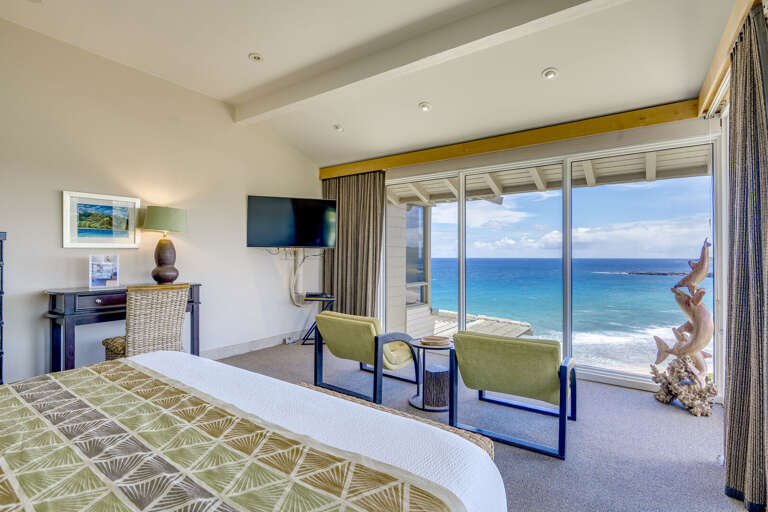 Amazing oceanfront bedroom with workspace.