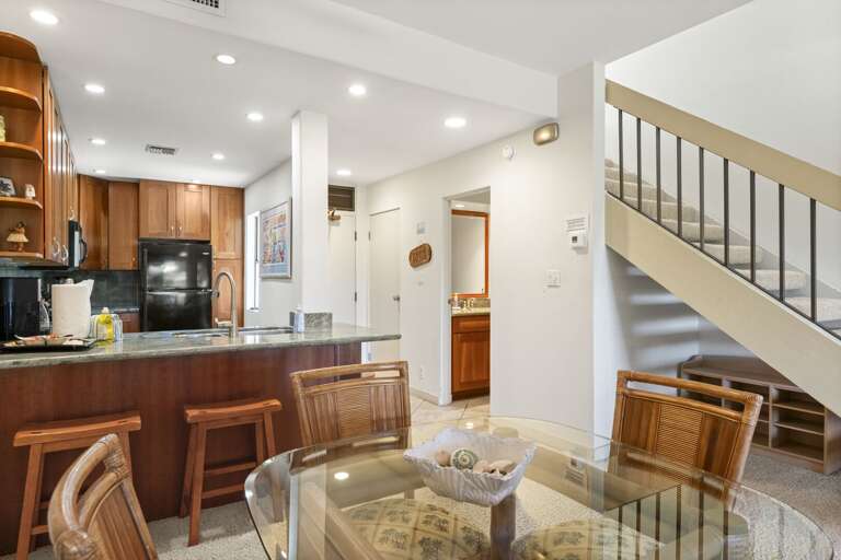 Dining table with kitchen view and across guest bathroom