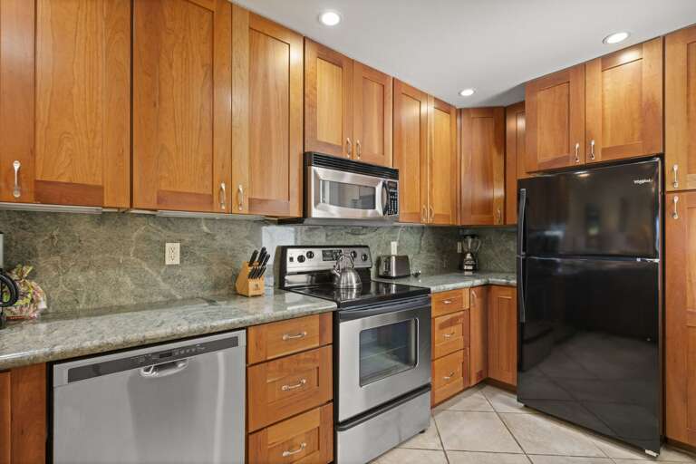 Full size appliances: Stainless steel stove, full-size refrigerator and dishwasher.