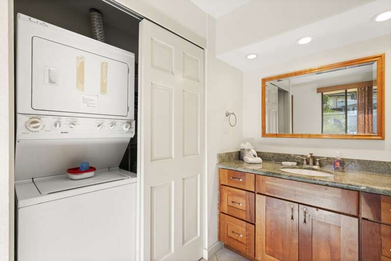 Stacked washer and dryer in unit for guest use