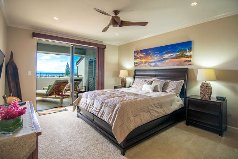king bed with ceiling fan and central a/c