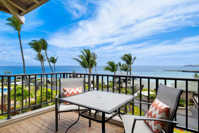 Balcony View Over Beach, Palm Trees, And Pool From Vacation Rental