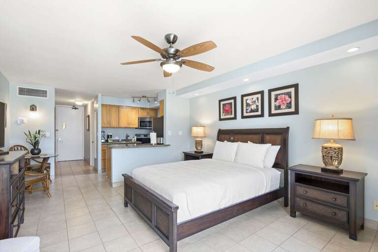 Bright Bedroom With Bed, Ceiling Fan, Kitchen Area