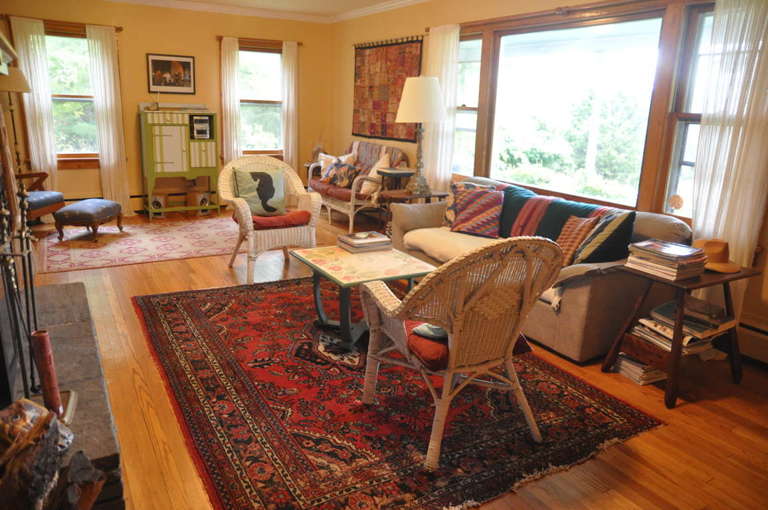 View of living room. Fireplace on left