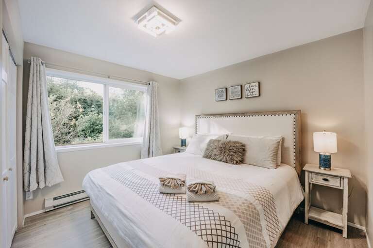 Main floor bedroom with a king bed and ensuite bath Main floor bedroom with a king bed and ensuite bath