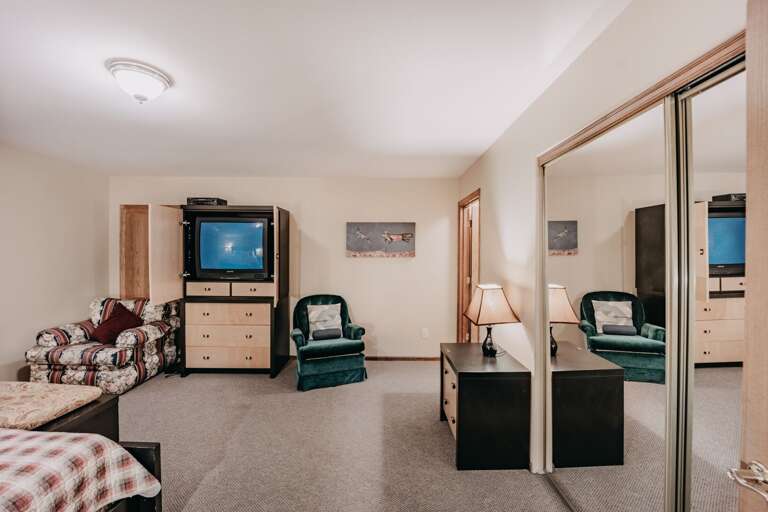 Main floor master bedroom with tv stand open