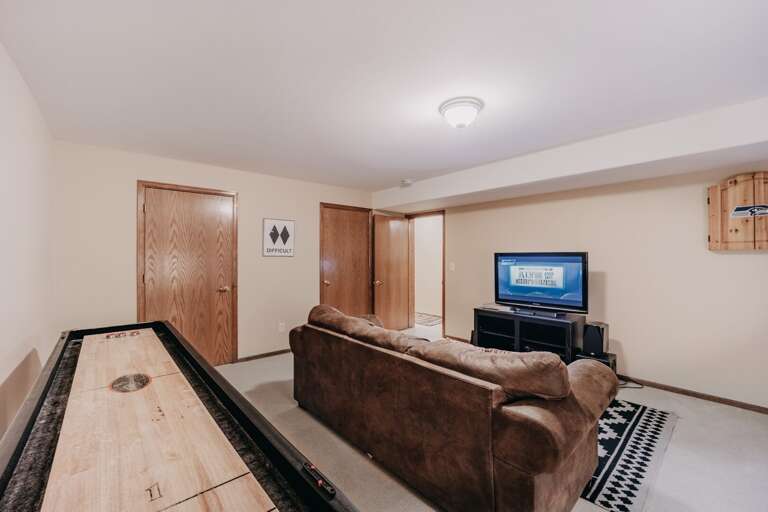 Another view of 1st floor living room with shuffle board